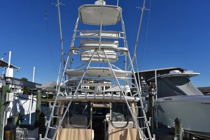 Slide: The Image of 2008 Tiara Sport Fish boat with tower, docked at marina under clear blue sky. - 6