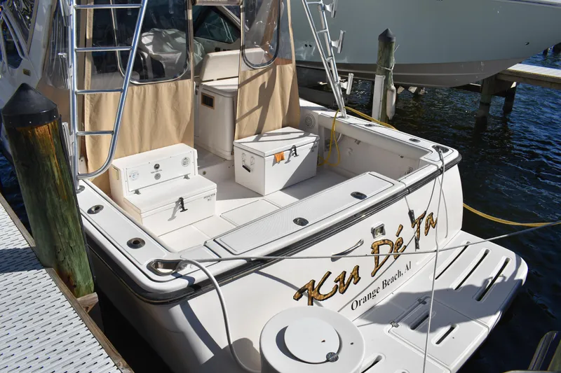 Slide: The Image of 2008 Tiara Sport Fish boat docked, featuring spacious deck and storage compartments. - 7