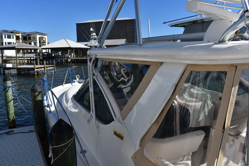 Slide: The Image of 2008 Tiara Sport Fish boat docked at marina, sunny day, waterfront buildings in background. - 8