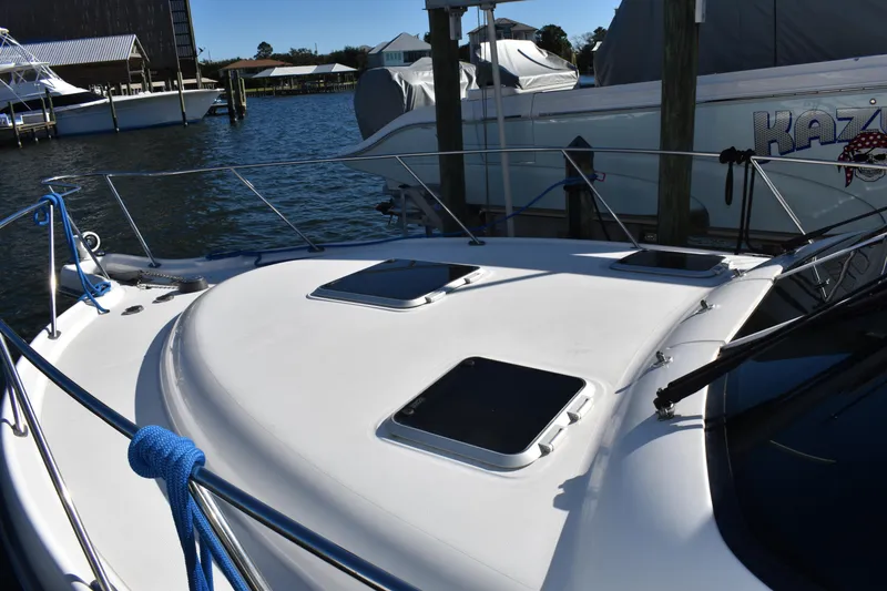 Slide: The Image of 2008 Tiara Sport Fish boat docked at marina, featuring sleek deck design. - 9