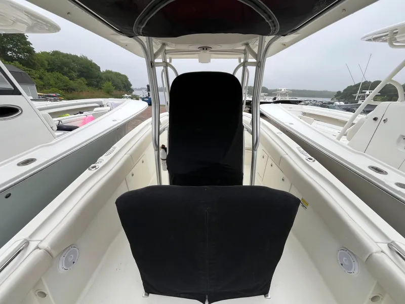 Slide: The Image of 2007 Hydra-Sports 2500CC boat interior with black seat covers, docked near other boats. - 18