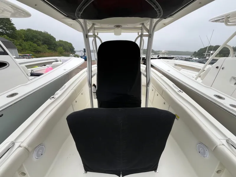 Slide: The Image of 2007 Hydra-Sports 2500CC boat interior with seating and console, docked near other boats. - 19