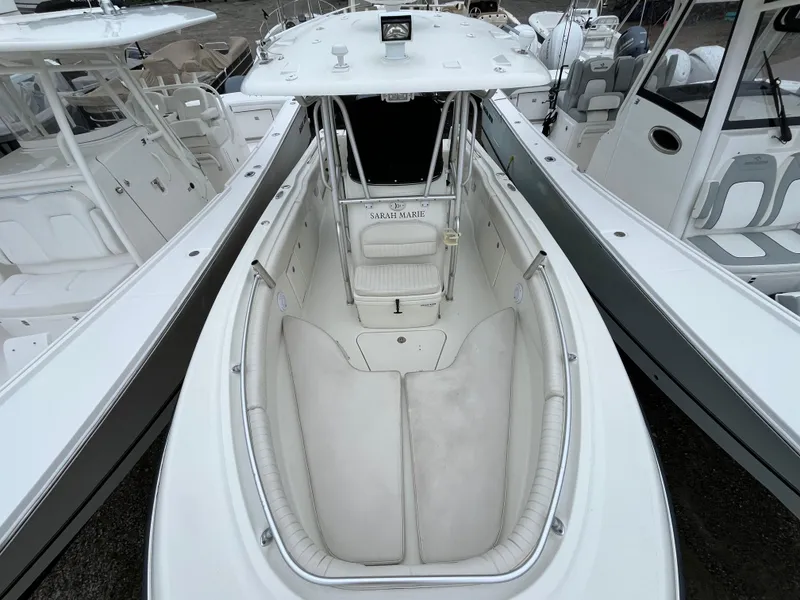 Slide: The Image of 2007 Hydra-Sports 2500CC boat interior with white seating and console, docked among other boats. - 23