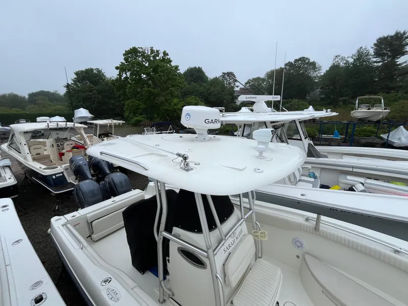 Slide: The Image of 2007 Hydra-Sports 2500CC boat with Garmin equipment, docked among other boats, surrounded by trees. - 24