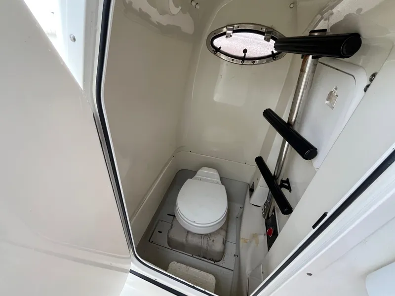 Slide: The Image of 2007 Hydra-Sports 2500CC boat interior with compact marine toilet and porthole window. - 27