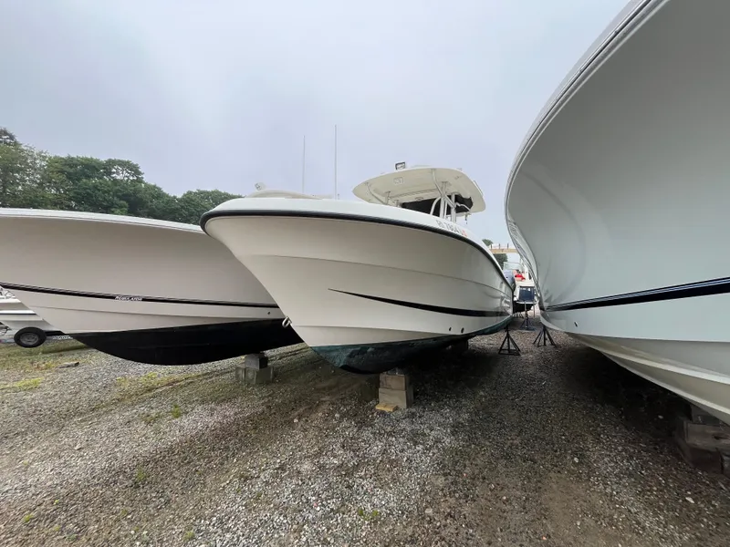 Slide: The Image of 2007 Hydra-Sports 2500CC boat on dry dock between two other boats. - 3