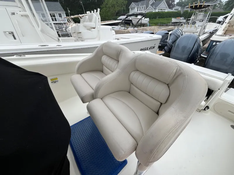 Slide: The Image of 2007 Hydra-Sports 2500CC boat with dual cushioned seats and outboard motors in a marina. - 34