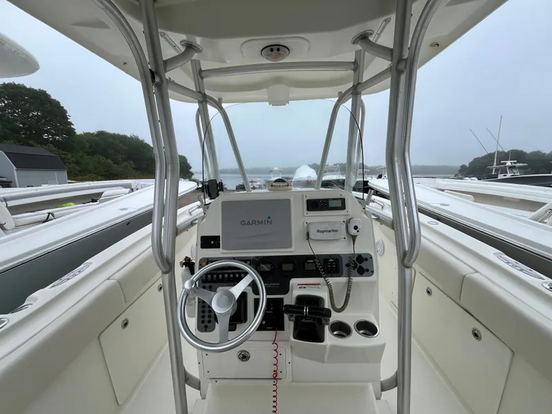 Slide: The Image of 2007 Hydra-Sports 2500CC boat cockpit with Garmin and Raymarine equipment, docked near water. - 37