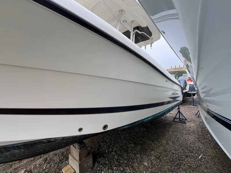 Slide: The Image of 2007 Hydra-Sports 2500CC boat on stands, side view, in a storage area. - 5