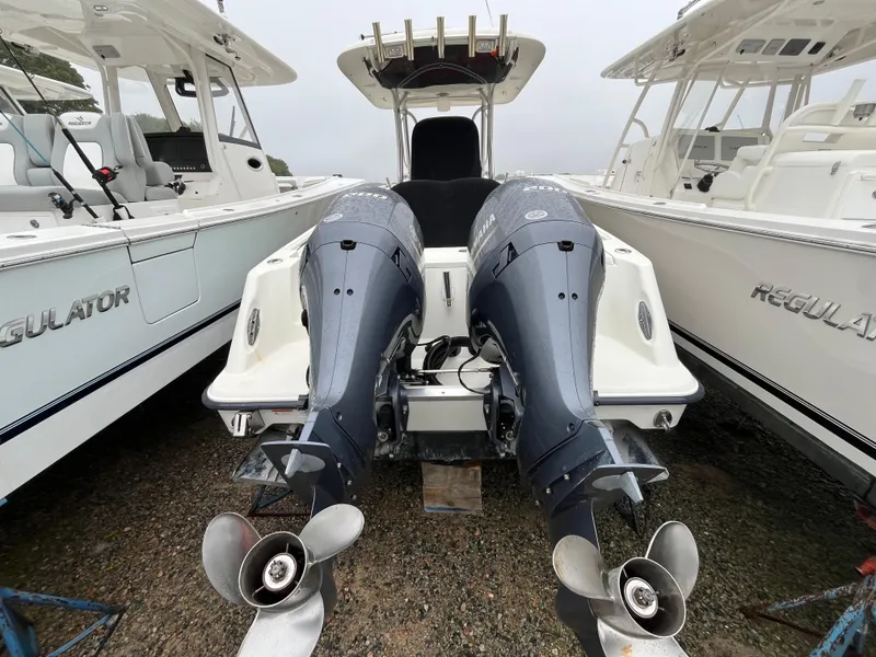 Slide: The Image of 2007 Hydra-Sports 2500CC boat with dual Yamaha outboard motors, docked between two Regulators. - 6
