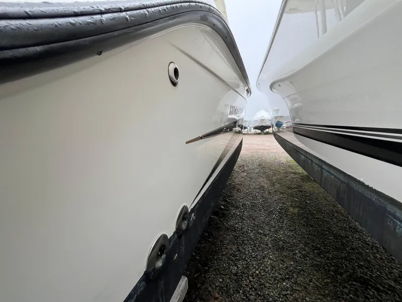 Slide: The Image of 2007 Hydra-Sports 2500CC boat hulls on gravel, side-by-side view. - 7
