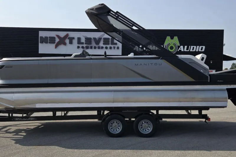 Slide: The Image of 2025 Manitou Explore pontoon boat on trailer at Next Level Powersports. - 5