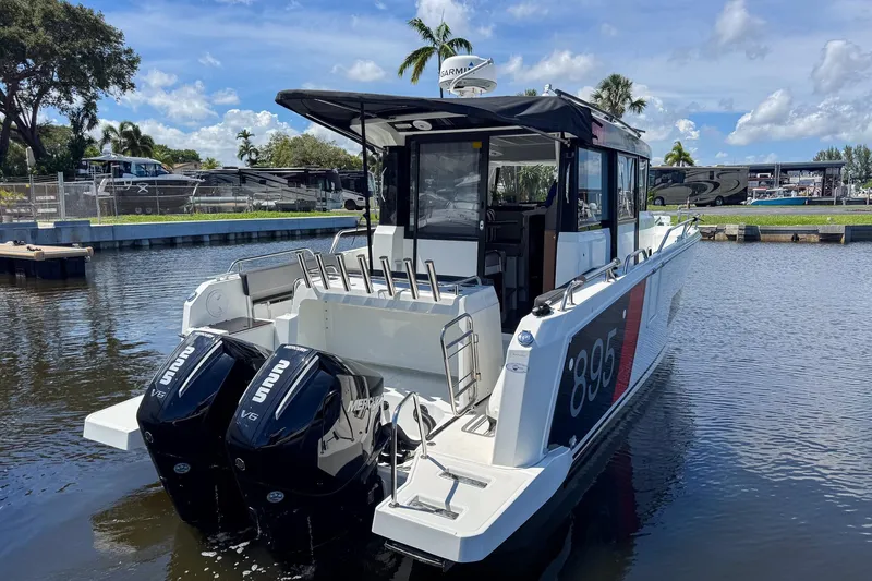 Slide: The Image of 2018 Jeanneau NC 895 boat with dual Mercury V6 engines docked on a sunny day. - 13