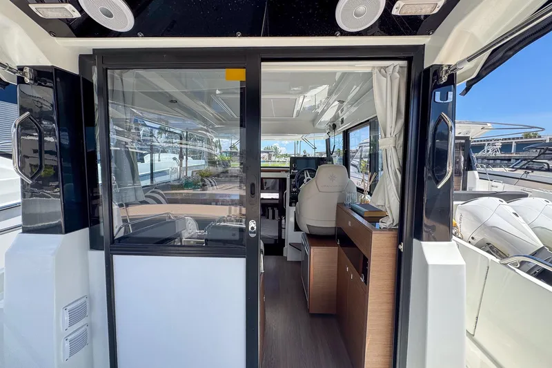 Slide: The Image of Interior view of 2018 Jeanneau NC 895 boat, featuring modern design and spacious cabin. - 14