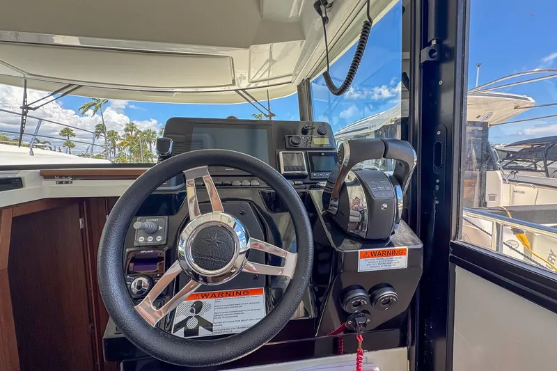 Slide: The Image of Helm of 2018 Jeanneau NC 895 boat with steering wheel and controls. - 18