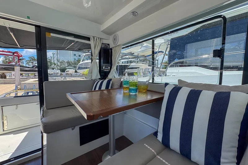 Slide: The Image of Interior of 2018 Jeanneau NC 895 boat with cozy seating and striped cushions. - 21