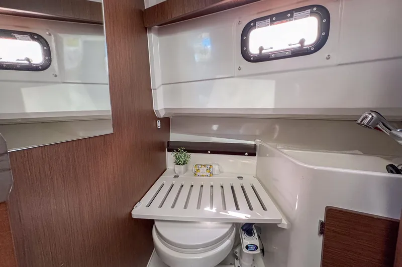 Slide: The Image of 2018 Jeanneau NC 895 boat bathroom with compact design and wooden accents. - 24