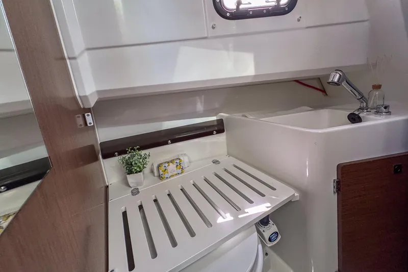 Slide: The Image of Compact bathroom in 2018 Jeanneau NC 895 boat with sink and toilet. - 25