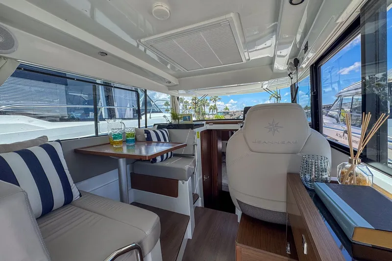 Slide: The Image of Interior of 2018 Jeanneau NC 895 boat with seating, table, and helm station. - 29