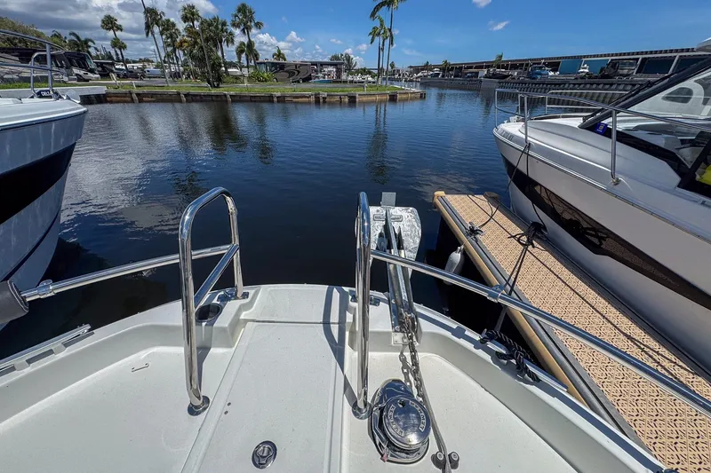 Slide: The Image of Bow view of 2018 Jeanneau NC 895 docked in a marina with palm trees. - 33