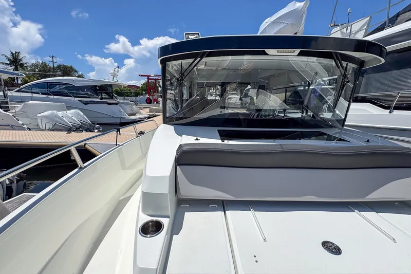 Slide: The Image of 2018 Jeanneau NC 895 boat docked under a clear blue sky. - 35