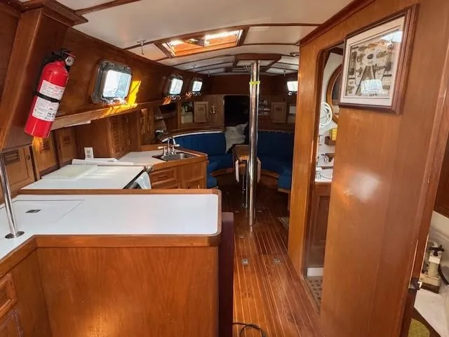 Slide: The Image of Interior of 1978 Cheoy Lee Off Shore 41 yacht with wooden finishes and blue seating. - 10