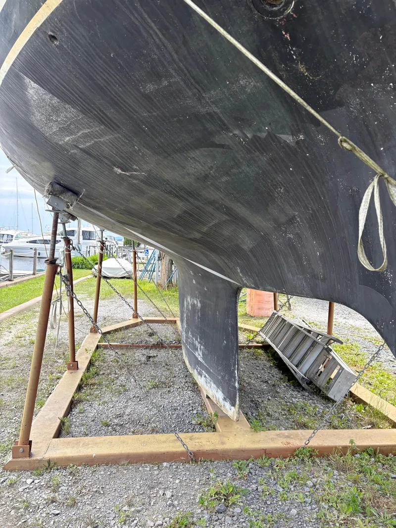 Slide: The Image of 1978 Cheoy Lee Off Shore 41 sailboat hull on dry dock, showing keel and support structure. - 6