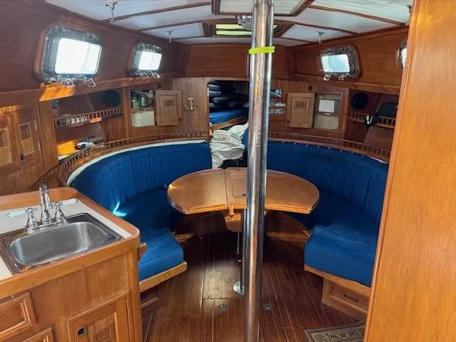 Slide: The Image of 1978 Cheoy Lee Off Shore 41 yacht interior with blue seating and wooden finishes. - 8