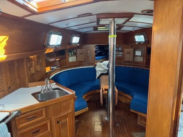 Slide: The Image of 1978 Cheoy Lee Off Shore 41 yacht interior with wood finish and blue seating. - 9