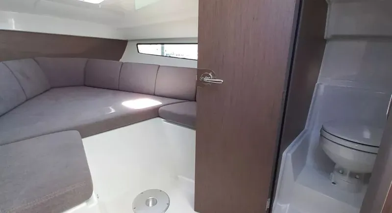 Slide: The Image of 2026 Beneteau FLYER 8 SUNDECK V2 interior with cozy seating and compact bathroom. - 2