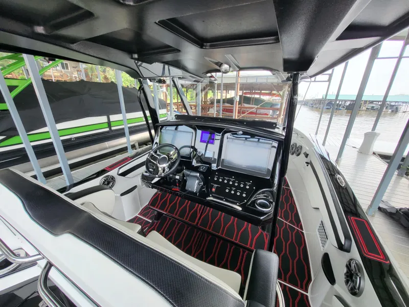 Slide: The Image of 2023 Sunsation 32 CCX boat interior with modern dashboard and steering wheel. - 12