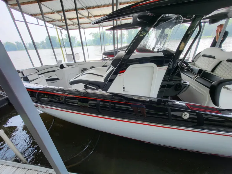 Slide: The Image of 2023 Sunsation 32 CCX boat docked under a covered marina. - 13