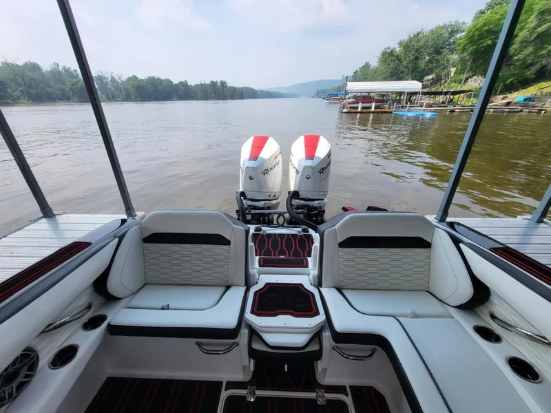 Slide: The Image of 2023 Sunsation 32 CCX boat interior with twin engines on a scenic river. - 14