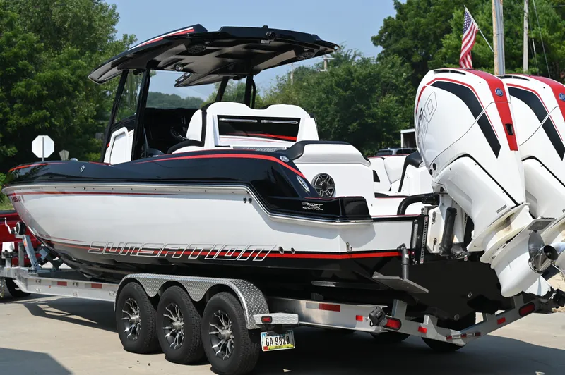Slide: The Image of 2023 Sunsation 32 CCX boat on trailer, featuring sleek design and powerful engines. - 2