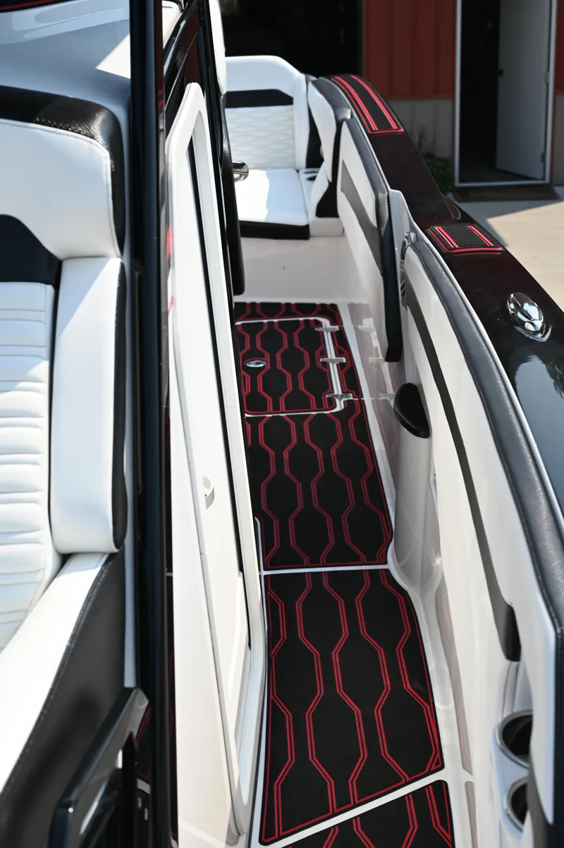 Slide: The Image of 2023 Sunsation 32 CCX boat interior with sleek black and red flooring design. - 21