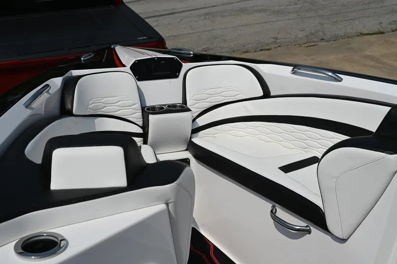 Slide: The Image of 2023 Sunsation 32 CCX boat interior with white and black seating, cup holders, and modern design. - 24