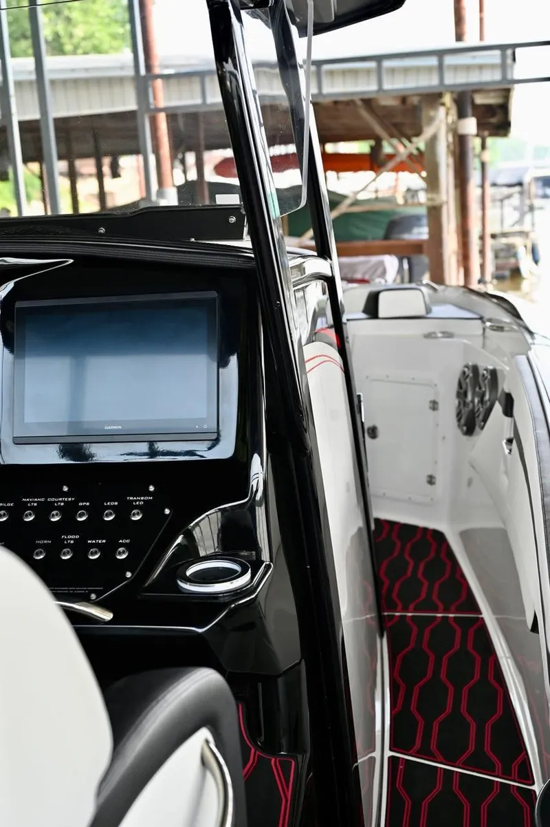 Slide: The Image of 2023 Sunsation 32 CCX boat interior with modern dashboard and stylish flooring. - 8