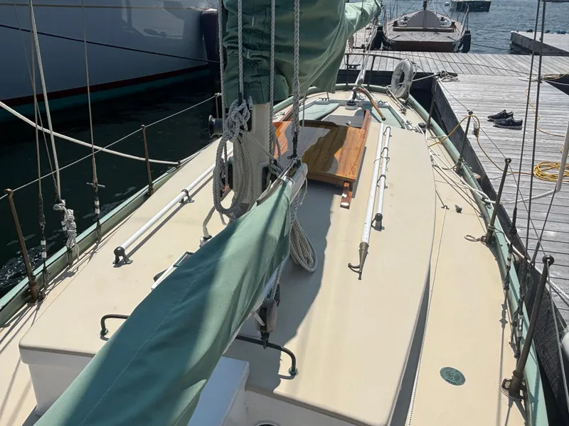 Slide: The Image of 1951 Custom Pilot Cutter sailboat docked, featuring deck and rigging details. - 19