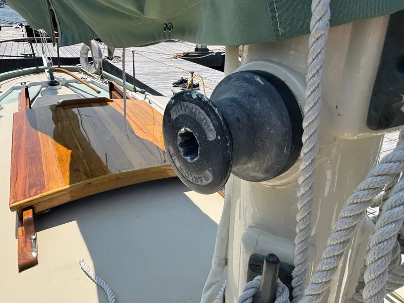 Slide: The Image of Close-up of a 1951 Custom Pilot Cutter's deck, featuring a winch and ropes. - 23