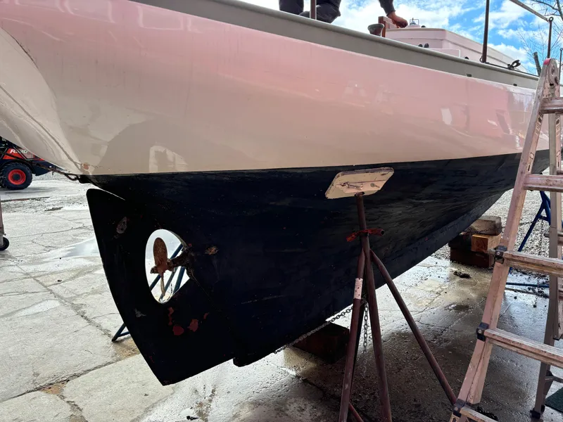 Slide: The Image of 1951 Custom Pilot Cutter on dry dock, showing hull and propeller maintenance. - 32