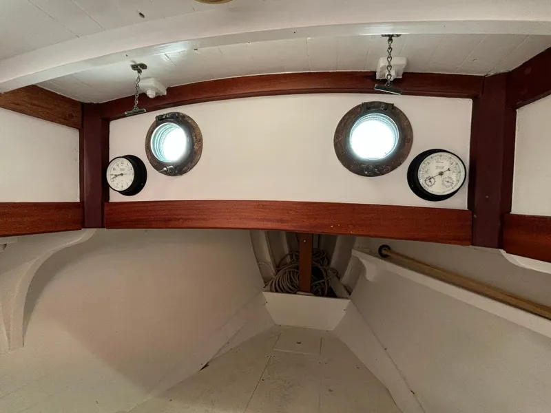 Slide: The Image of Interior of a 1951 Custom Pilot Cutter with portholes and nautical instruments. - 36