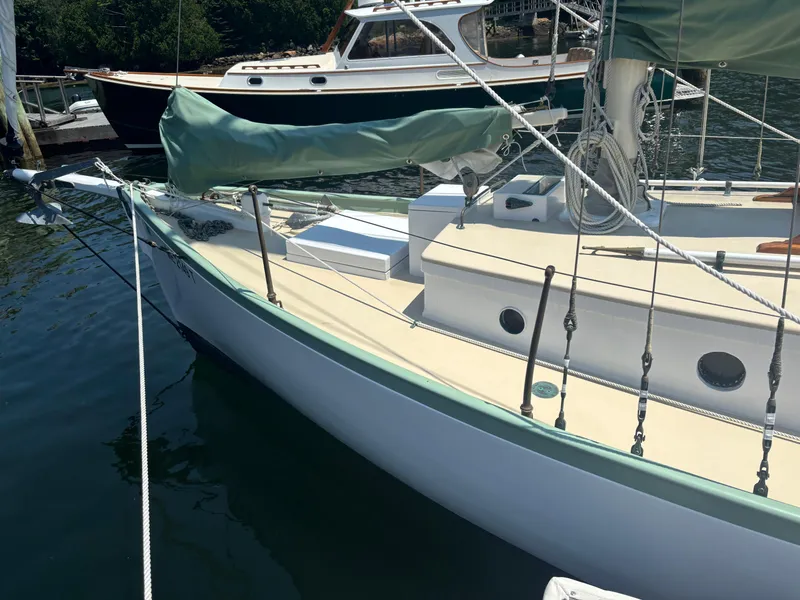 Slide: The Image of Vintage 1951 Custom Pilot Cutter sailboat docked in a marina. - 4