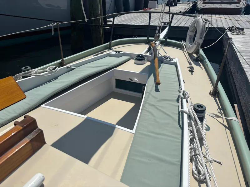 Slide: The Image of 1951 Custom Pilot Cutter deck with ropes and life preserver at dock. - 5