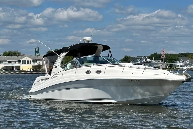 The Image of 2007 Sea Ray 340 Sundancer boat on trailer at marina. - 0