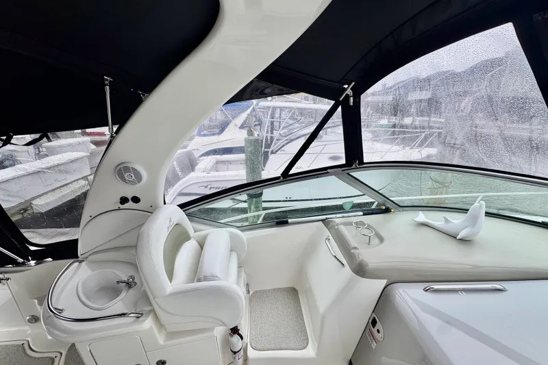 Slide: The Image of 2007 Sea Ray 340 Sundancer interior with white seating and wooden table. - 13