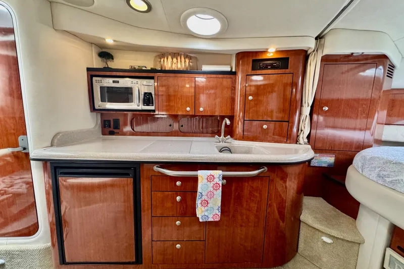 Slide: The Image of 2007 Sea Ray 340 Sundancer helm with steering wheel and control panel. - 16