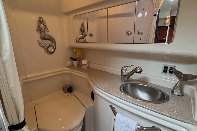 Slide: The Image of 2007 Sea Ray 340 Sundancer interior with cozy seating, wooden table, and elegant cabin design. - 18