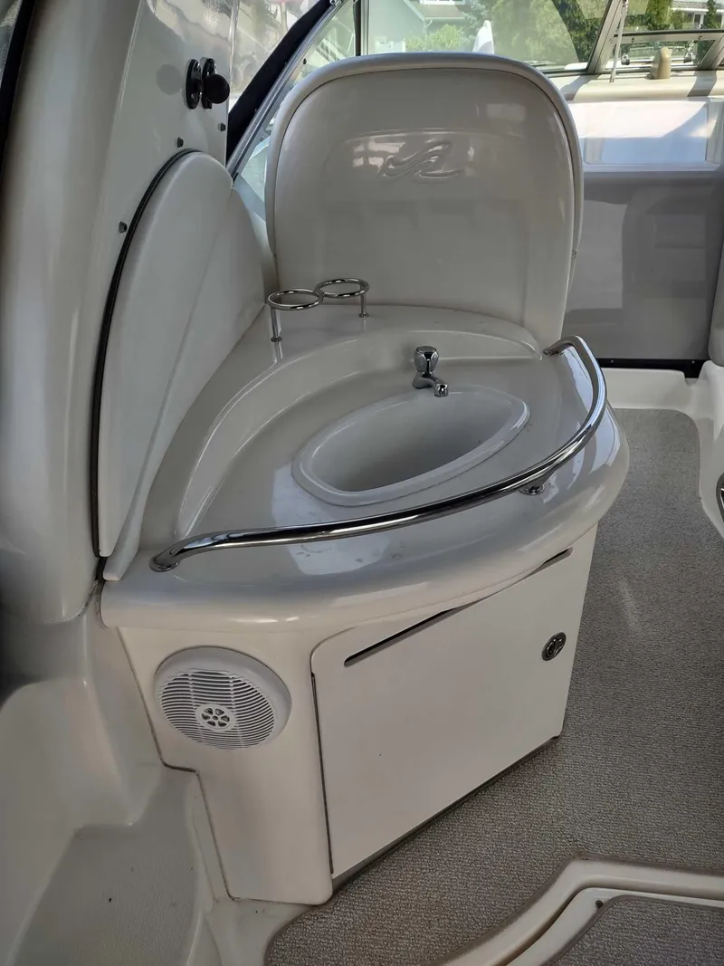 Slide: The Image of 2007 Sea Ray 340 Sundancer boat on calm water, featuring a sleek white design and black canopy. - 6