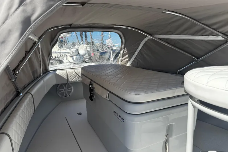 Slide: The Image of 2019 Dorado 25 Flat Deck interior with cushioned seating and storage under canopy. - 10