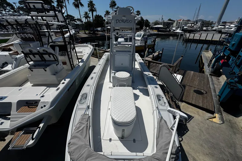 Slide: The Image of 2019 Dorado 25 Flat Deck boat docked at marina, surrounded by other vessels. - 11